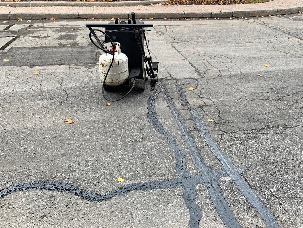 asphalt cracks repaired on a city road