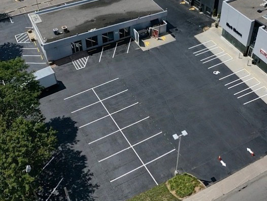 new parking stalls and markings painted in car dealership parking lot