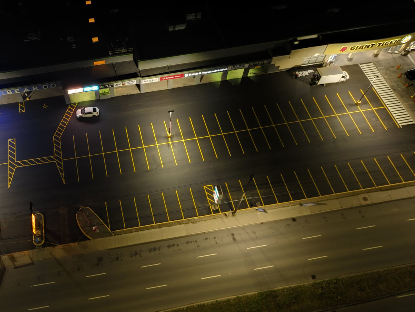 large parking lot with freshly painted yellow parking stall lines
