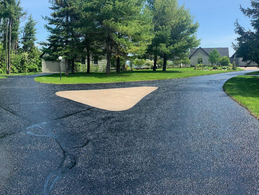 large country driveway with recently sealed asphalt