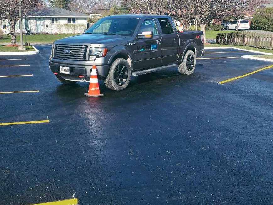 commerical parking lot with freshly sealed asphalt